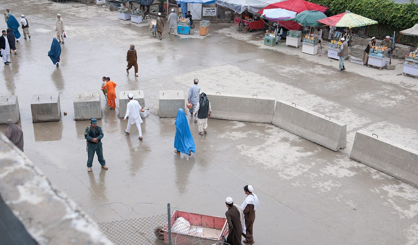 An Afghan security officer standing guard outside a customs station at Torkham