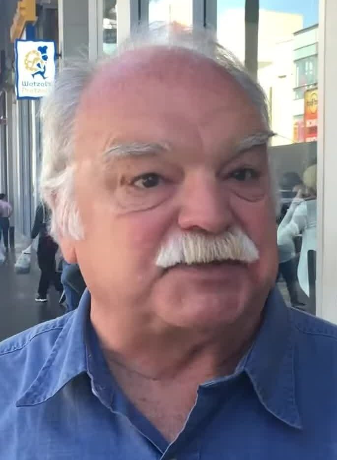 Richard Riehle with a white mustache smiling at an event in 2016