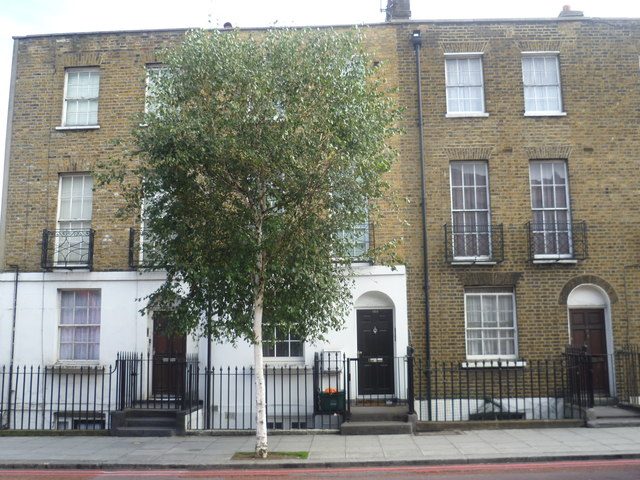 A row of brick terraced houses along a street