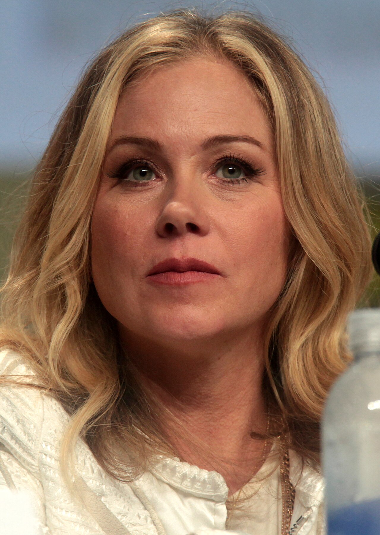 Christina Applegate speaking into a microphone on a panel
