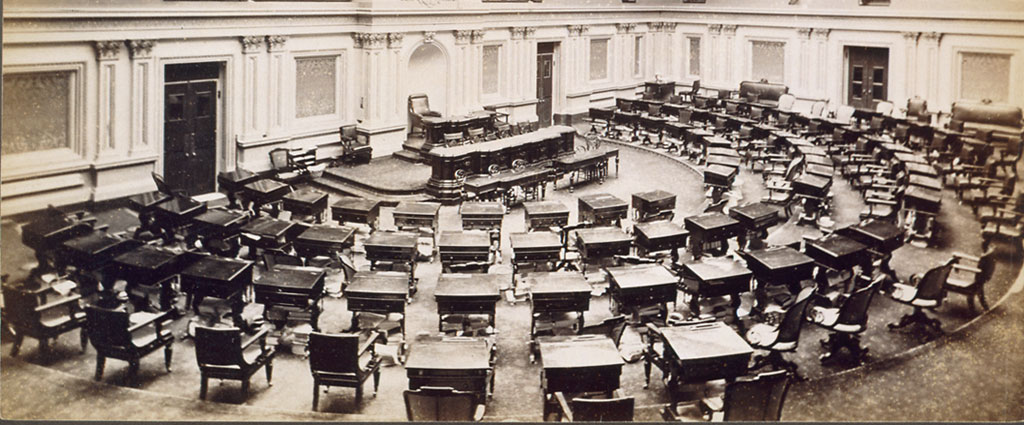 Rows of wooden desks in the US Senate chamber