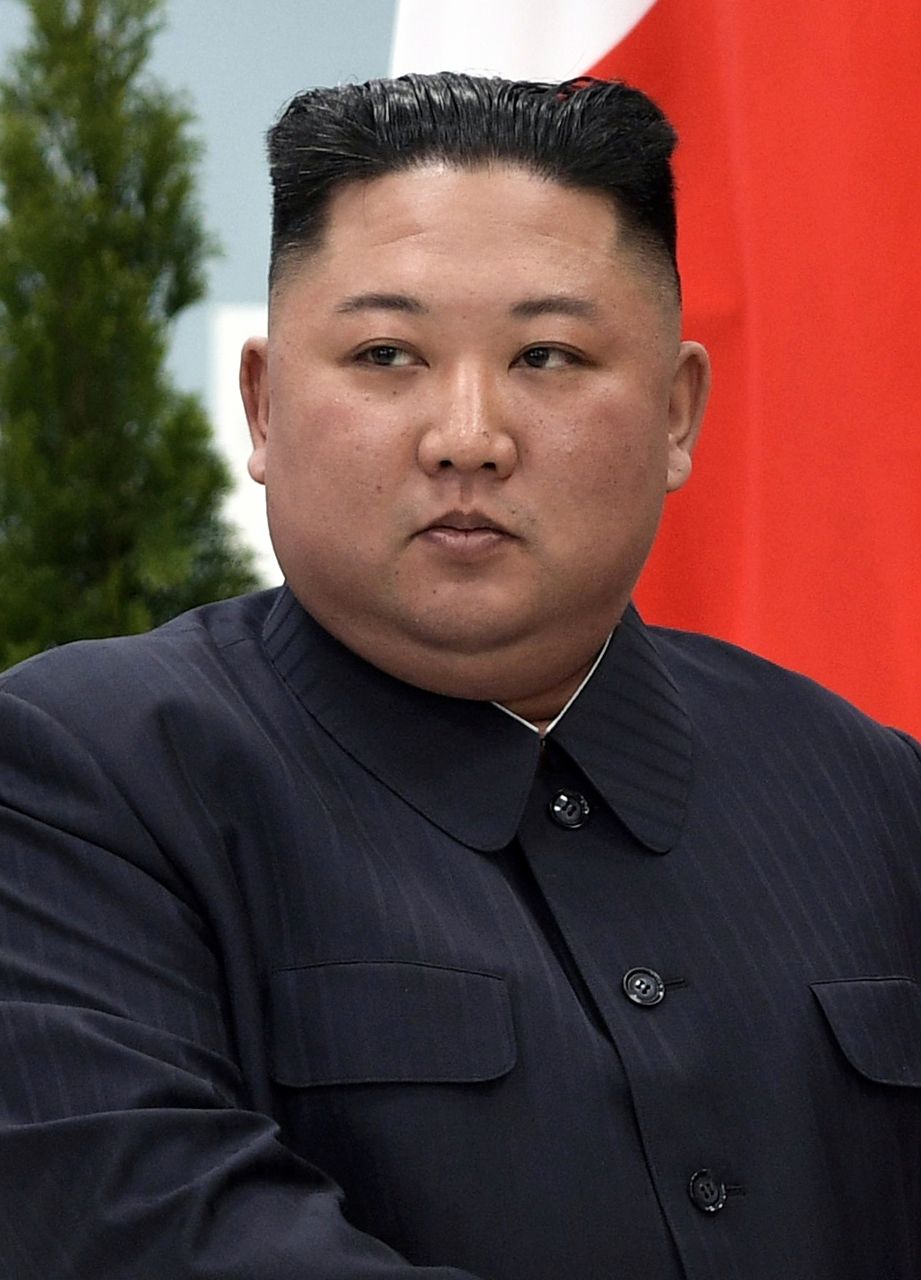 Kim Jong Un in a dark suit at a meeting