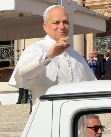 Pope Leo XIV waving from the popemobile