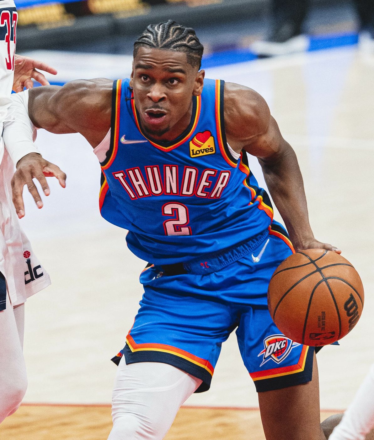 Shai Gilgeous-Alexander dribbling in a blue Thunder uniform