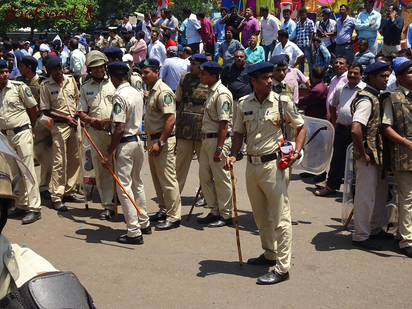 A group of police officers standing near a protest in Goa, India