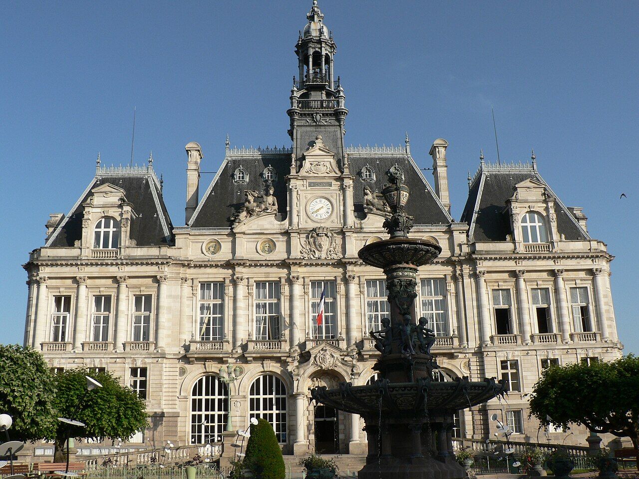 The ornate stone city hall of Limoges with its tall central clock tower