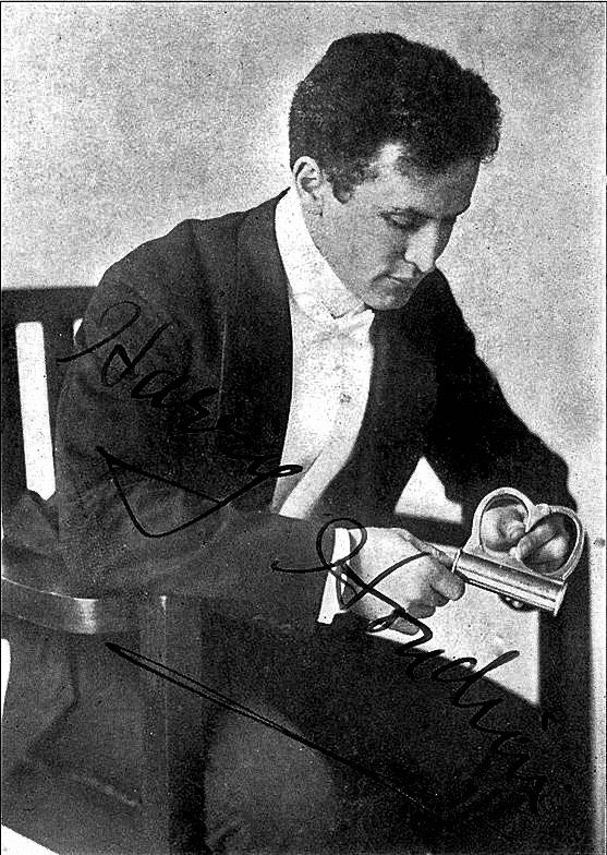 A black-and-white portrait of Harry Houdini seated