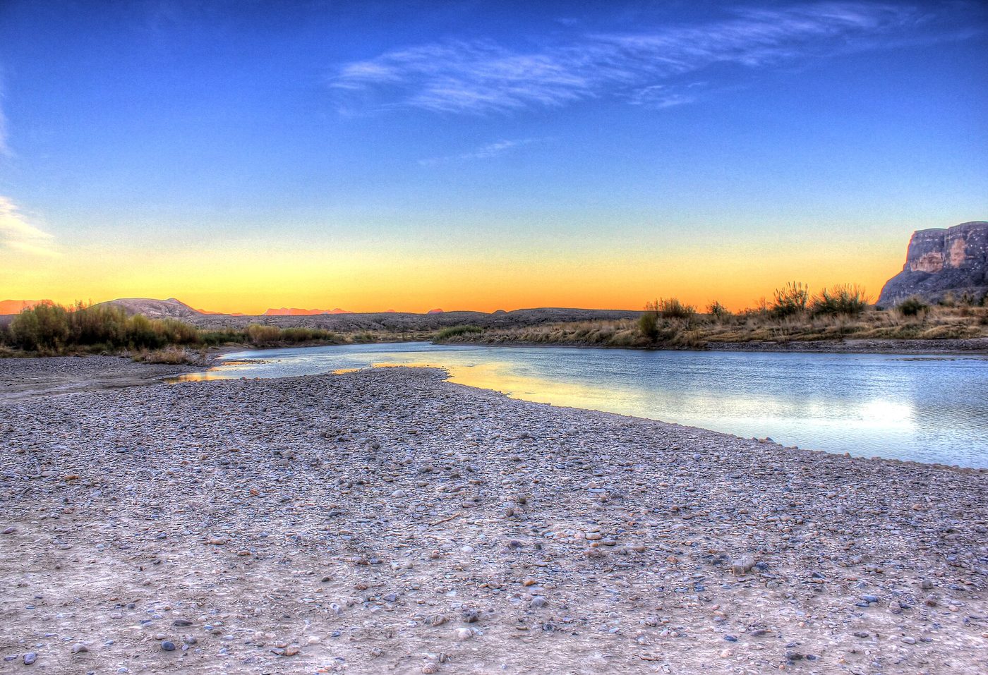 The Rio Grande at dusk in Big Bend National Park, with mountains behind