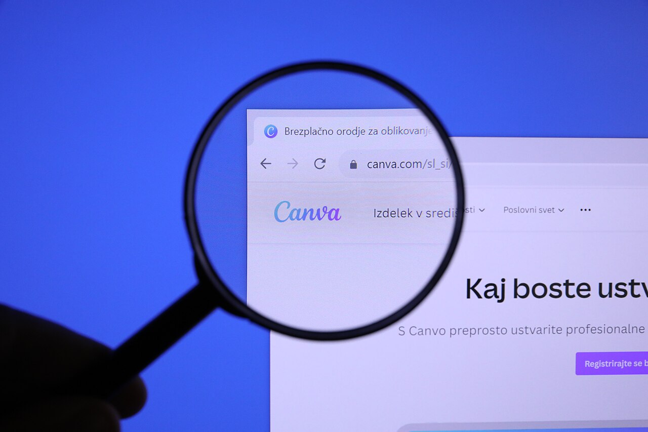 The Canva logo on its website seen through a magnifying glass