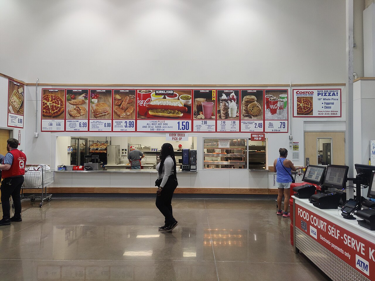 The front of a Costco warehouse store with its red sign