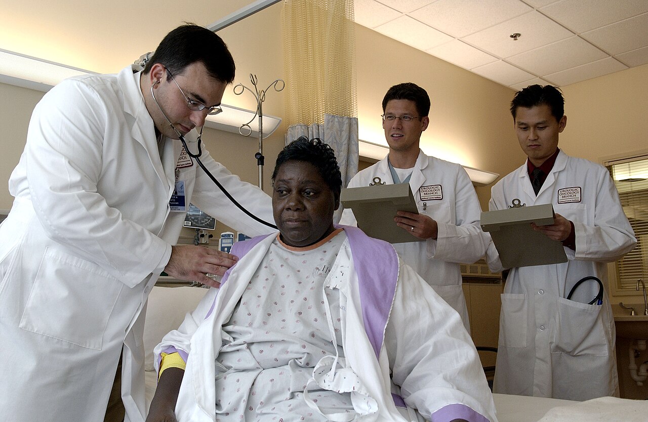 A doctor uses a stethoscope to examine a patient