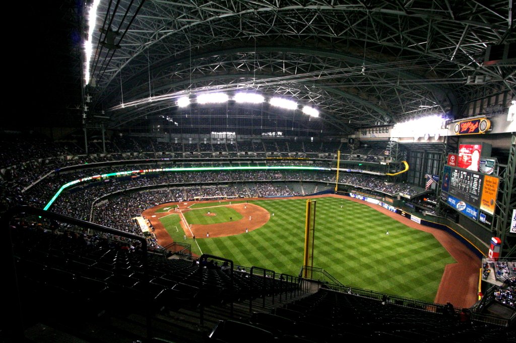 A wide view of a baseball stadium at night under the lights