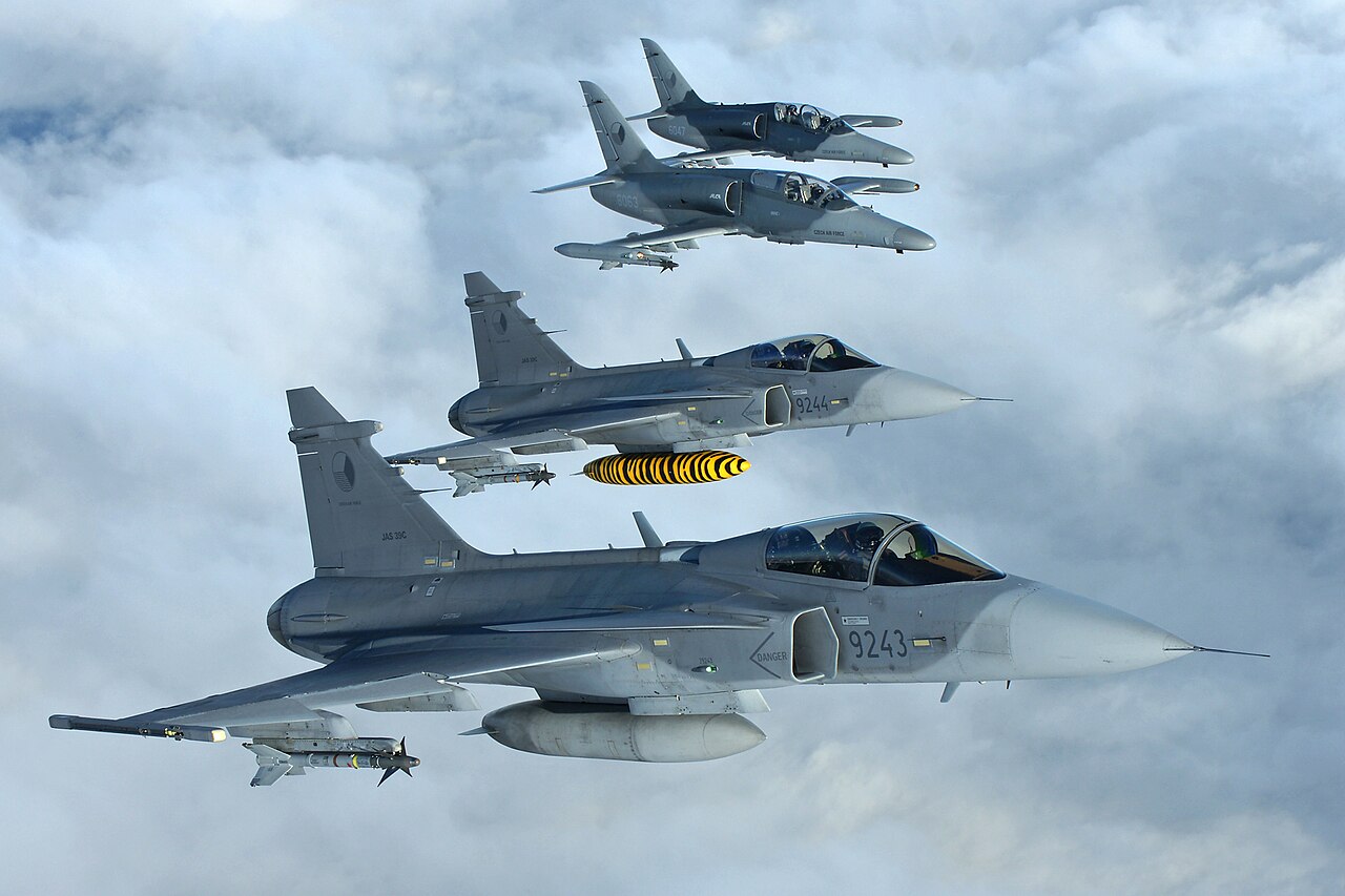 Two Saab Gripen fighter jets and two other military jets of the Czech Air Force flying in formation