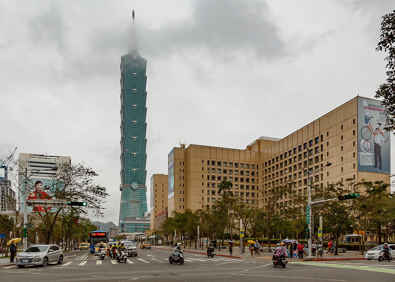 Taipei City Hall with the Taipei 101 tower in clouds behind it
