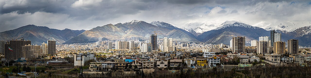 The Tehran skyline with mountains behind it on a clear day