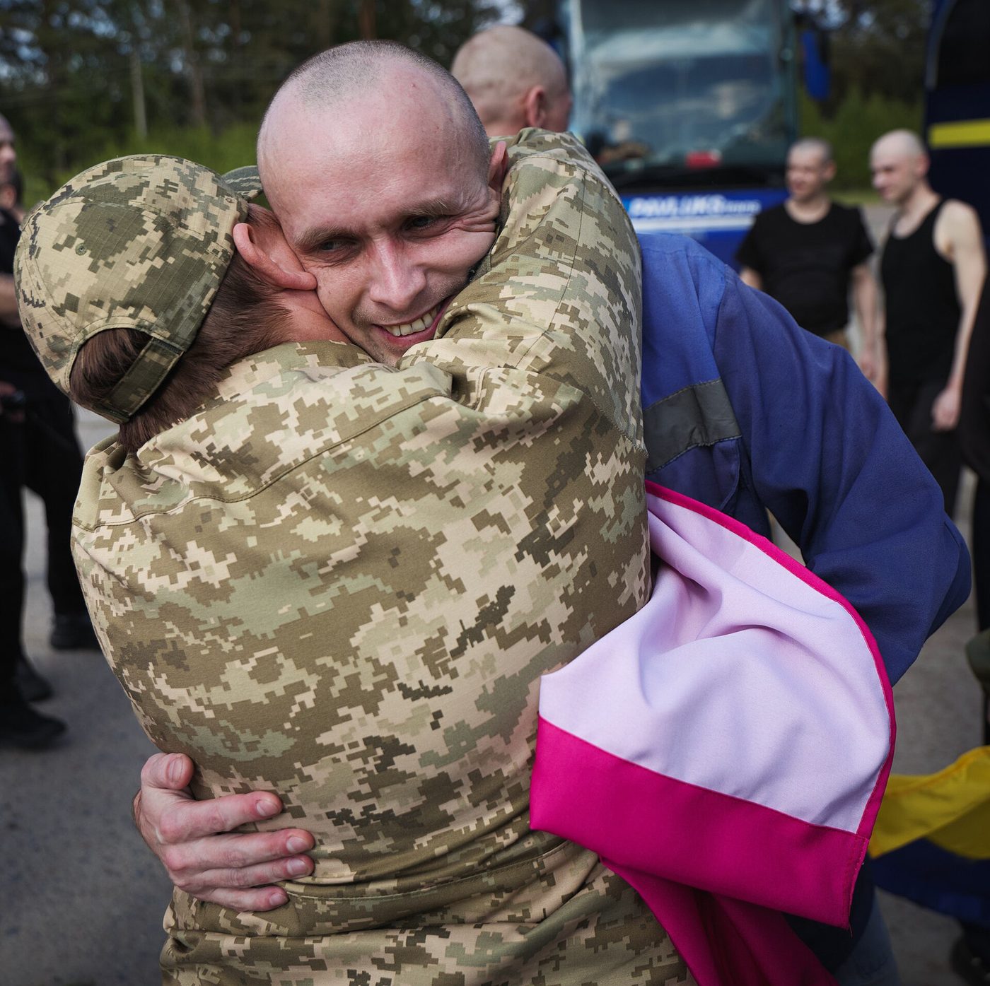 People hugging at a prisoner exchange event in Ukraine in 2025
