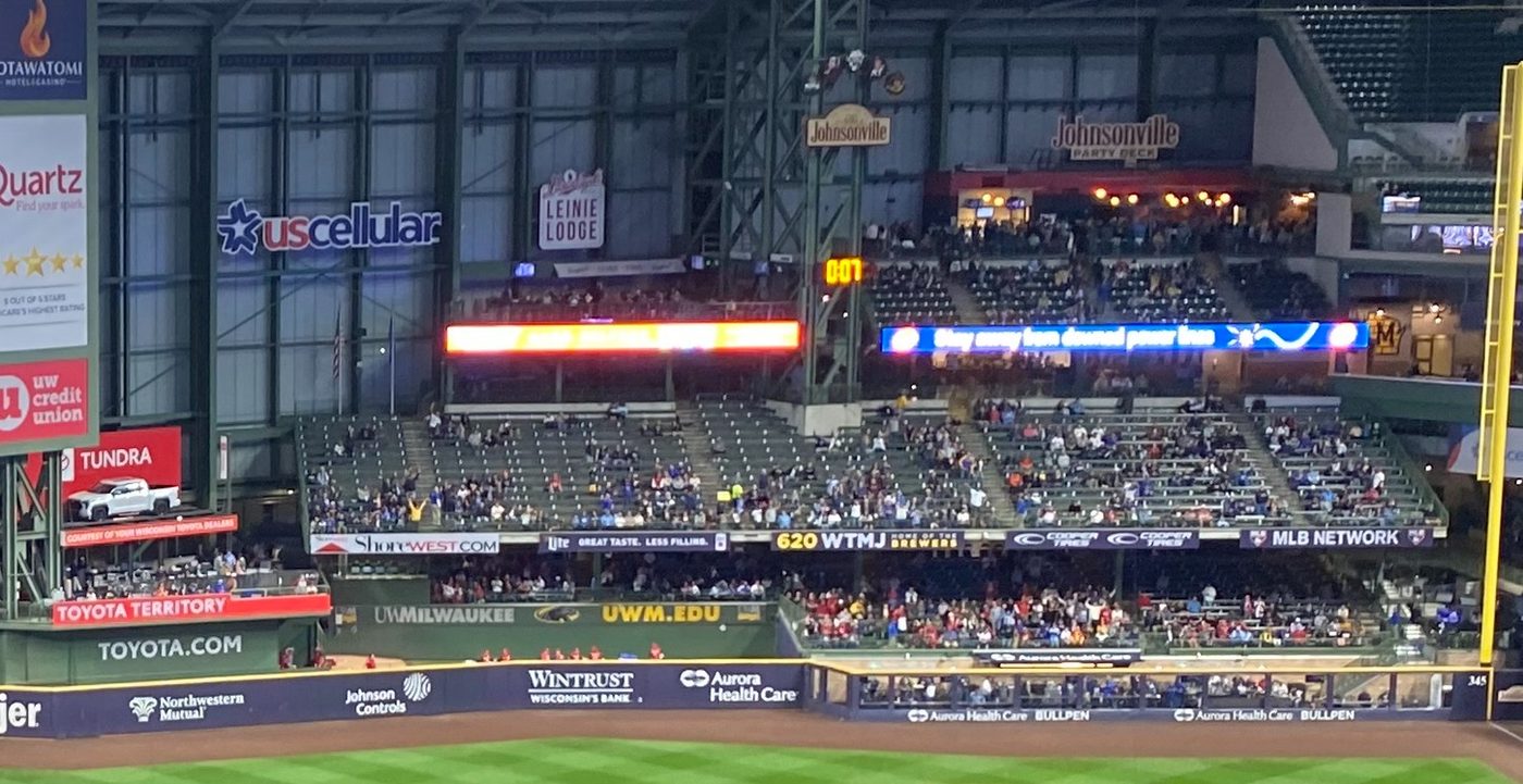 American Family Field's right field seating is seen, with particular emphasis here on the pitch clock in the center of the image.