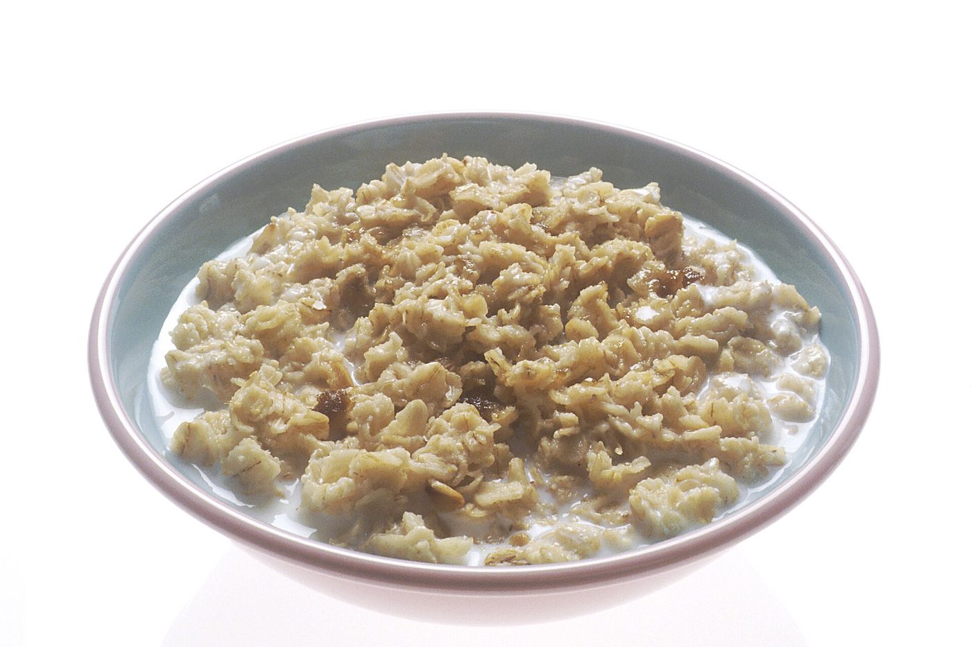 Bowl of cooked oatmeal with milk
