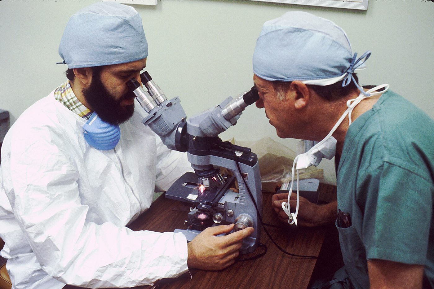 Pathologists examining tissue under microscopes