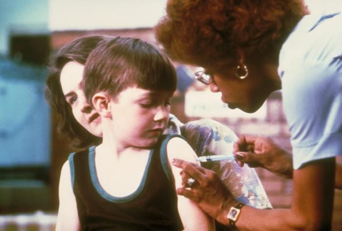 A nurse vaccinating a child