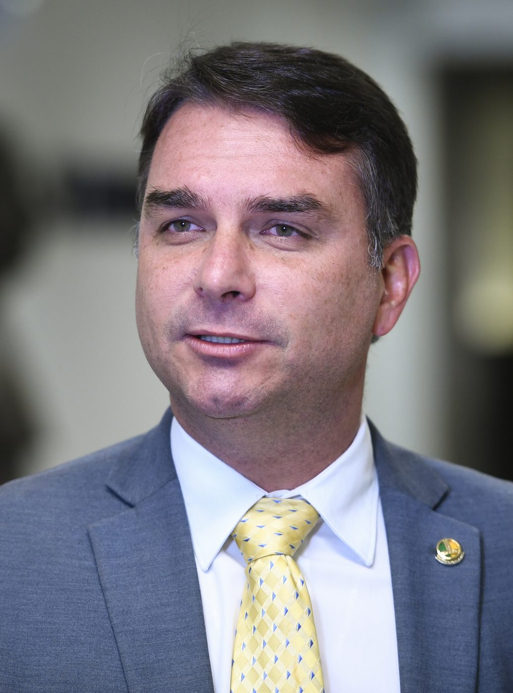 Brazilian senator Flavio Bolsonaro speaking at a microphone