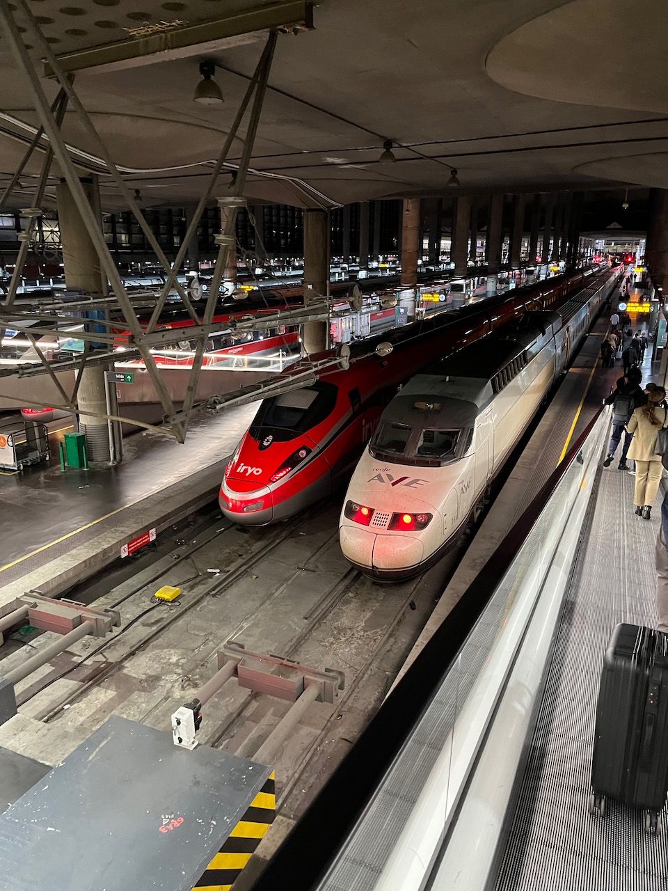 File photo of a Renfe AVE train and an Iryo Frecciarossa train at Madrid Atocha station in 2023