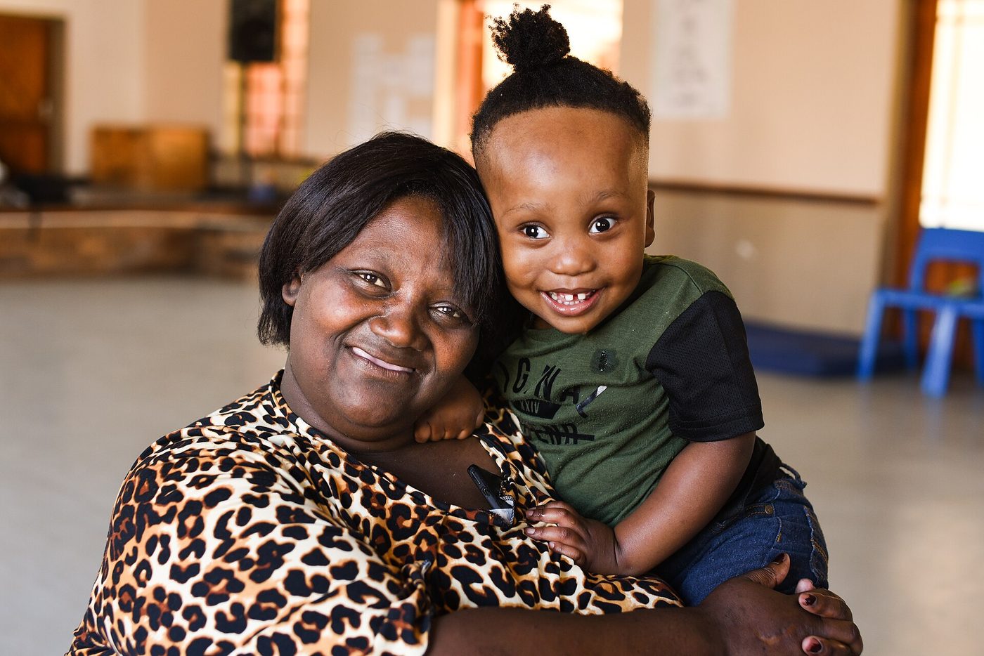 A grandmother sits with her grandson