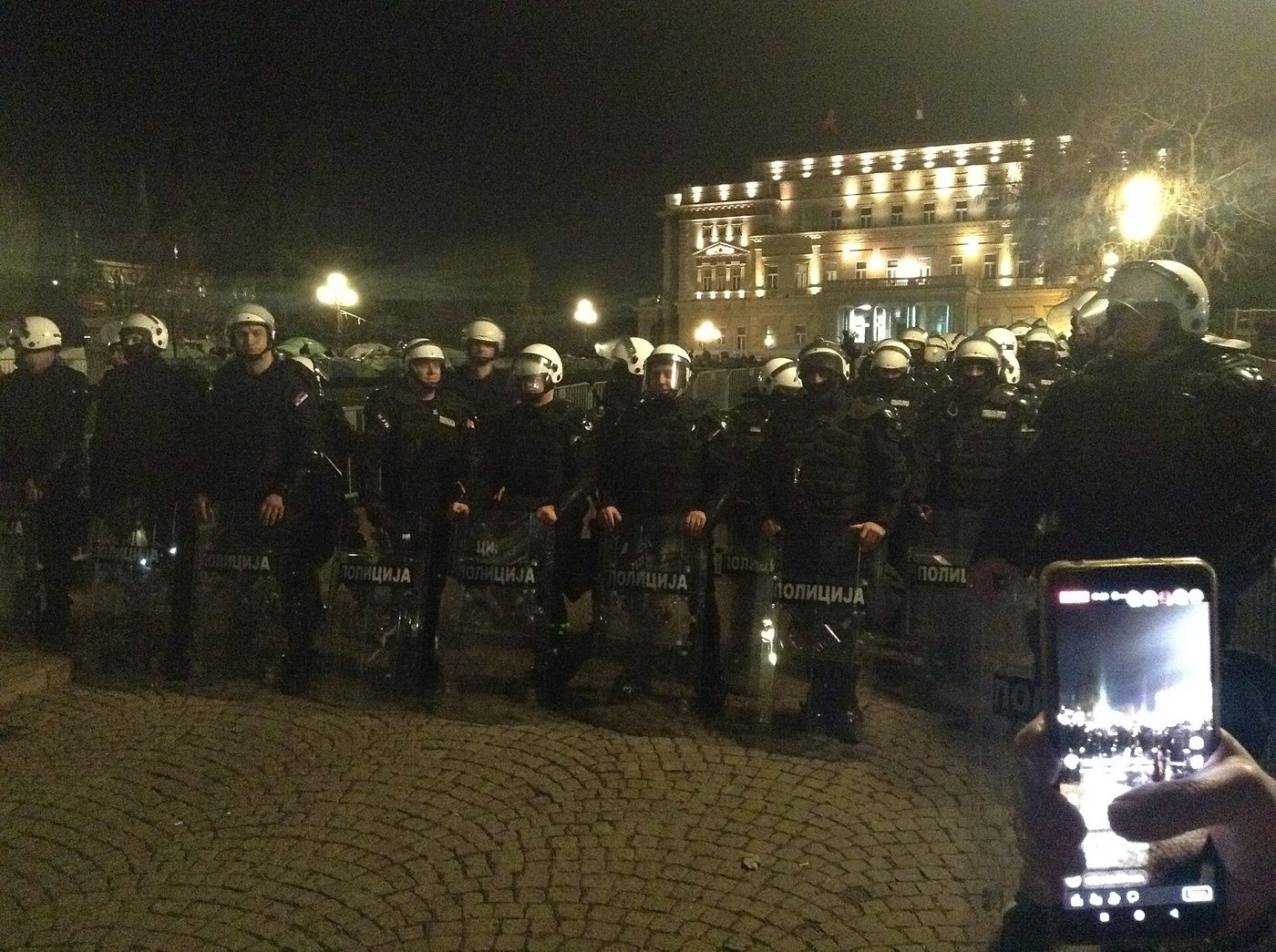 Crowds and police in central Belgrade on the eve of a protest