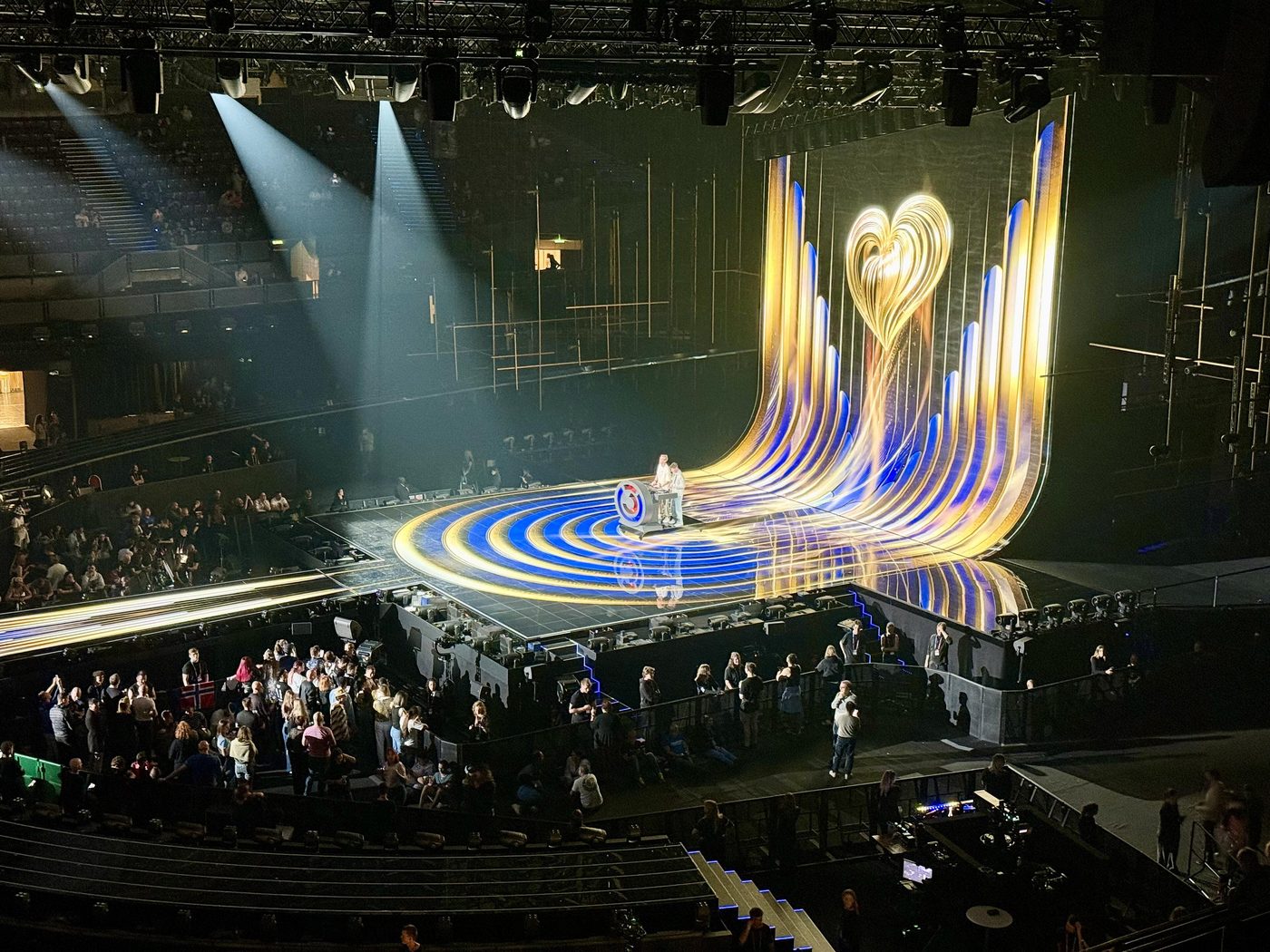 The lit stage of the 2026 Eurovision Song Contest in Vienna with crowds in the arena