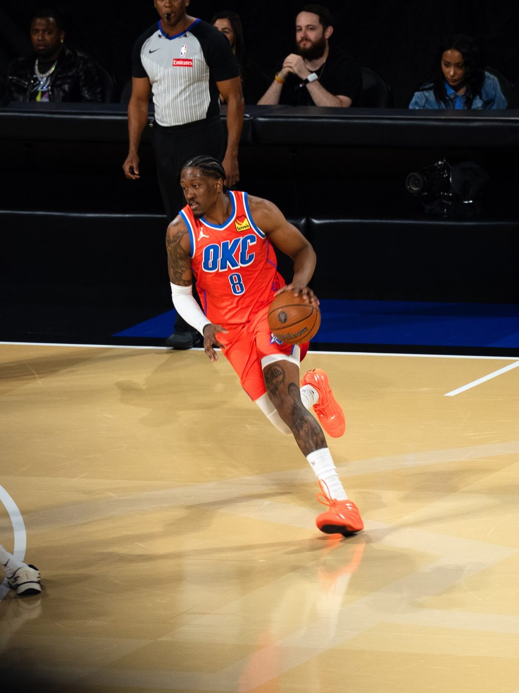Jalen Williams dribbles the ball in an orange Thunder uniform