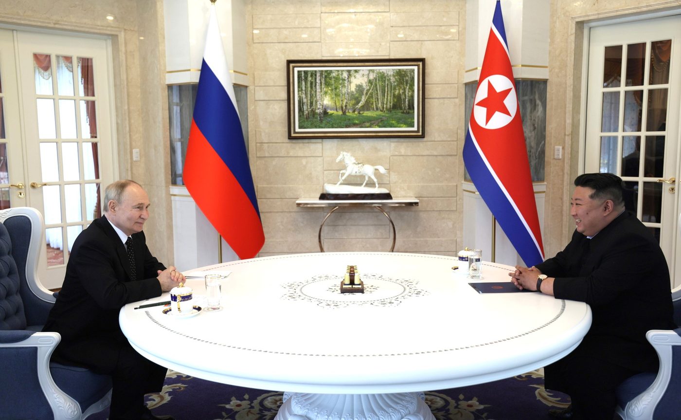 Vladimir Putin and Kim Jong Un talking in Pyongyang