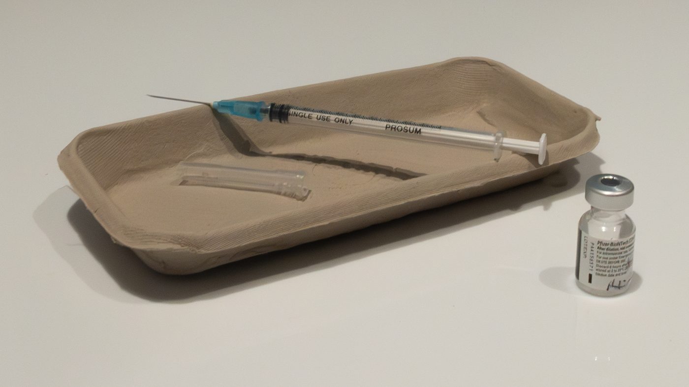 A vaccine vial and a syringe