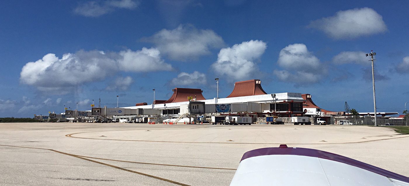 Terminal of Saipan International Airport under a blue sky