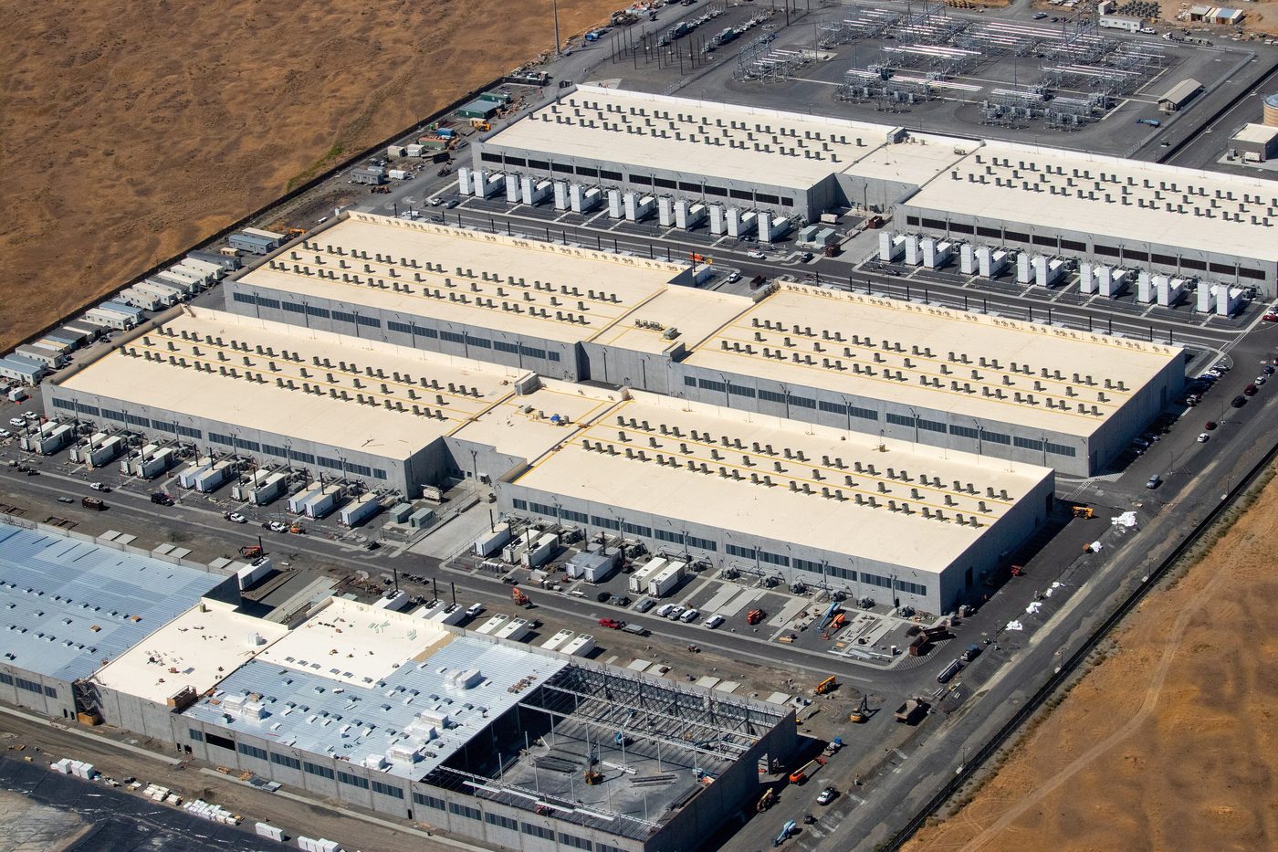 Aerial view of large gray Amazon data center buildings in Oregon