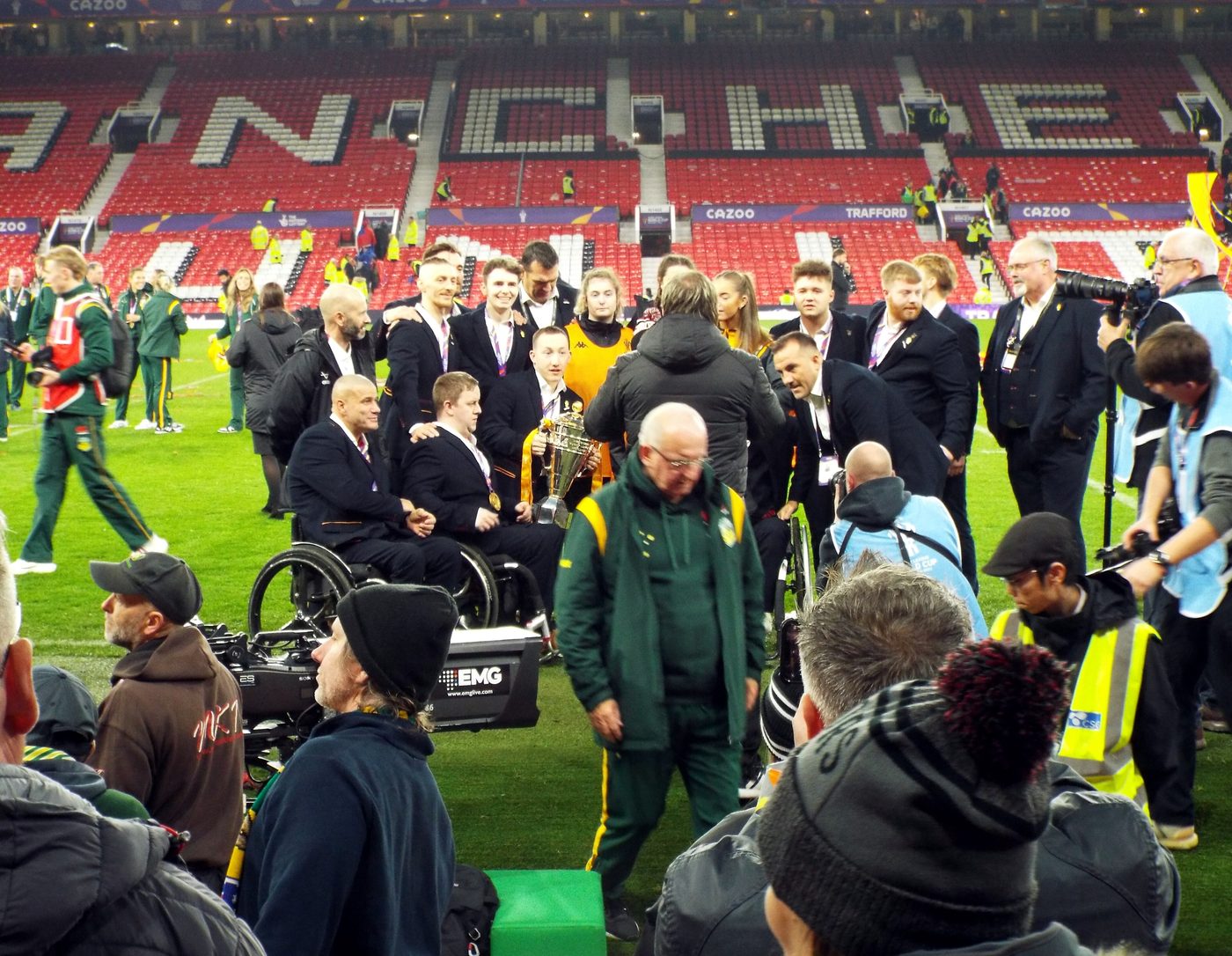 England wheelchair rugby league players celebrate on the field at Old Trafford
