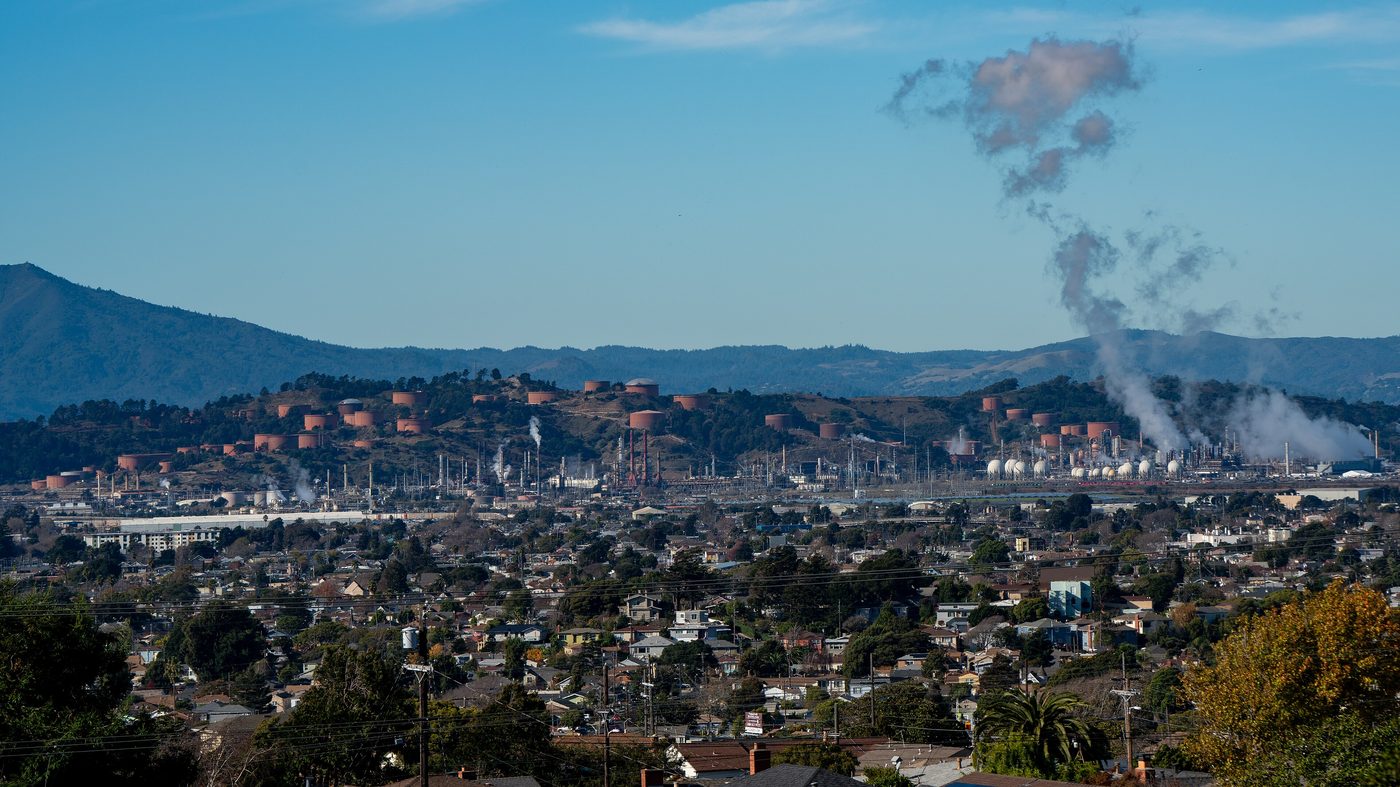 The Chevron refinery in Richmond, California, seen from a hill with steam rising