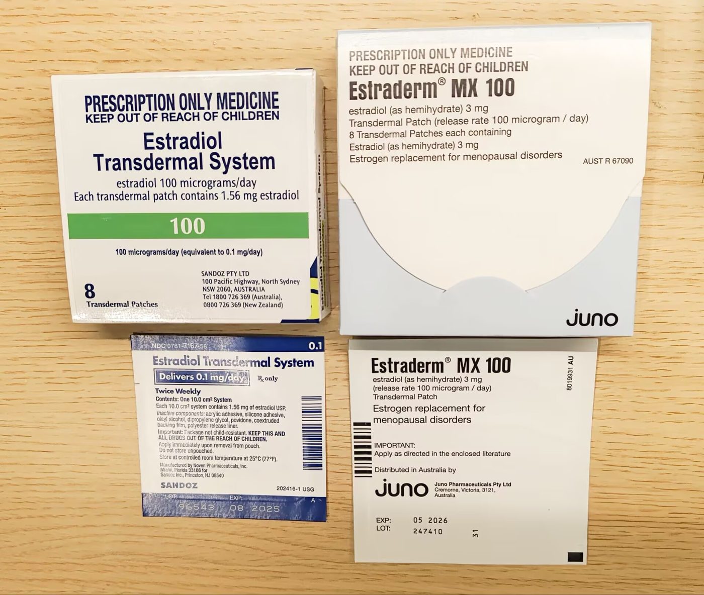 Boxes of estradiol skin patches with their product labels, laid out on a wooden table