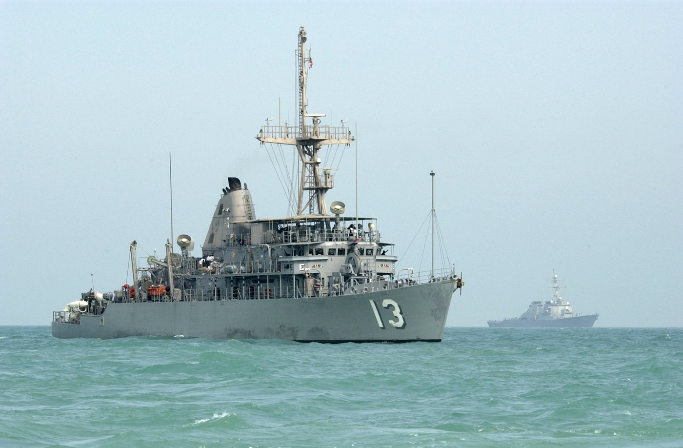 A gray US Navy minesweeping ship at sea