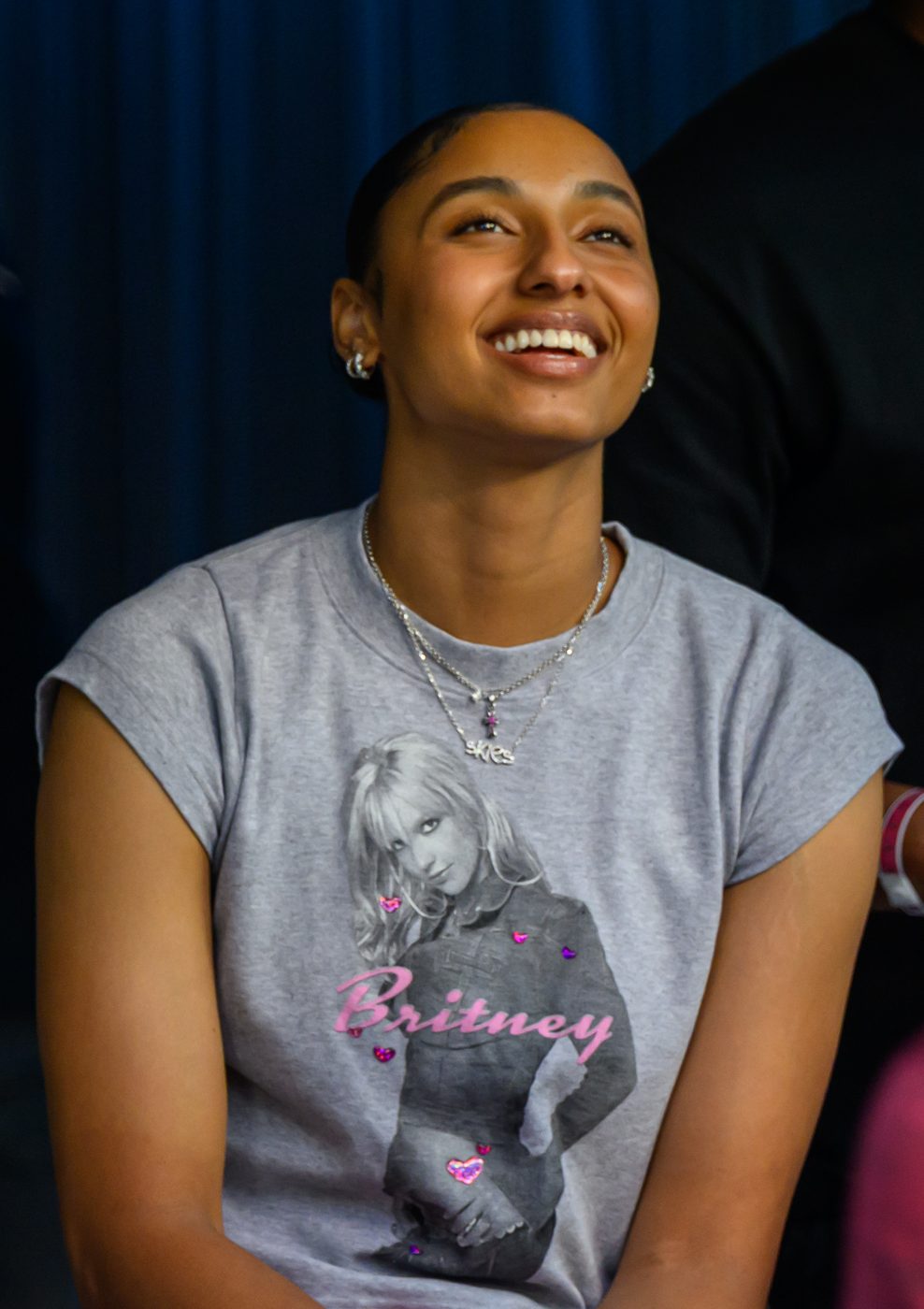 USC basketball star JuJu Watkins in a gray T-shirt at a football game