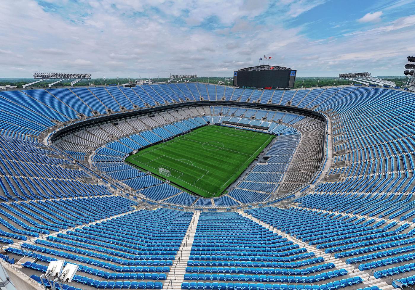 Aerial view of Bank of America Stadium with a green field and blue seats