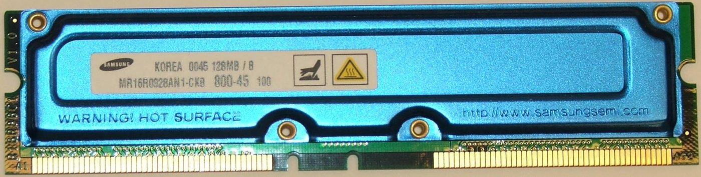 A green Rambus RDRAM computer memory module with a metal heat spreader, photographed against white