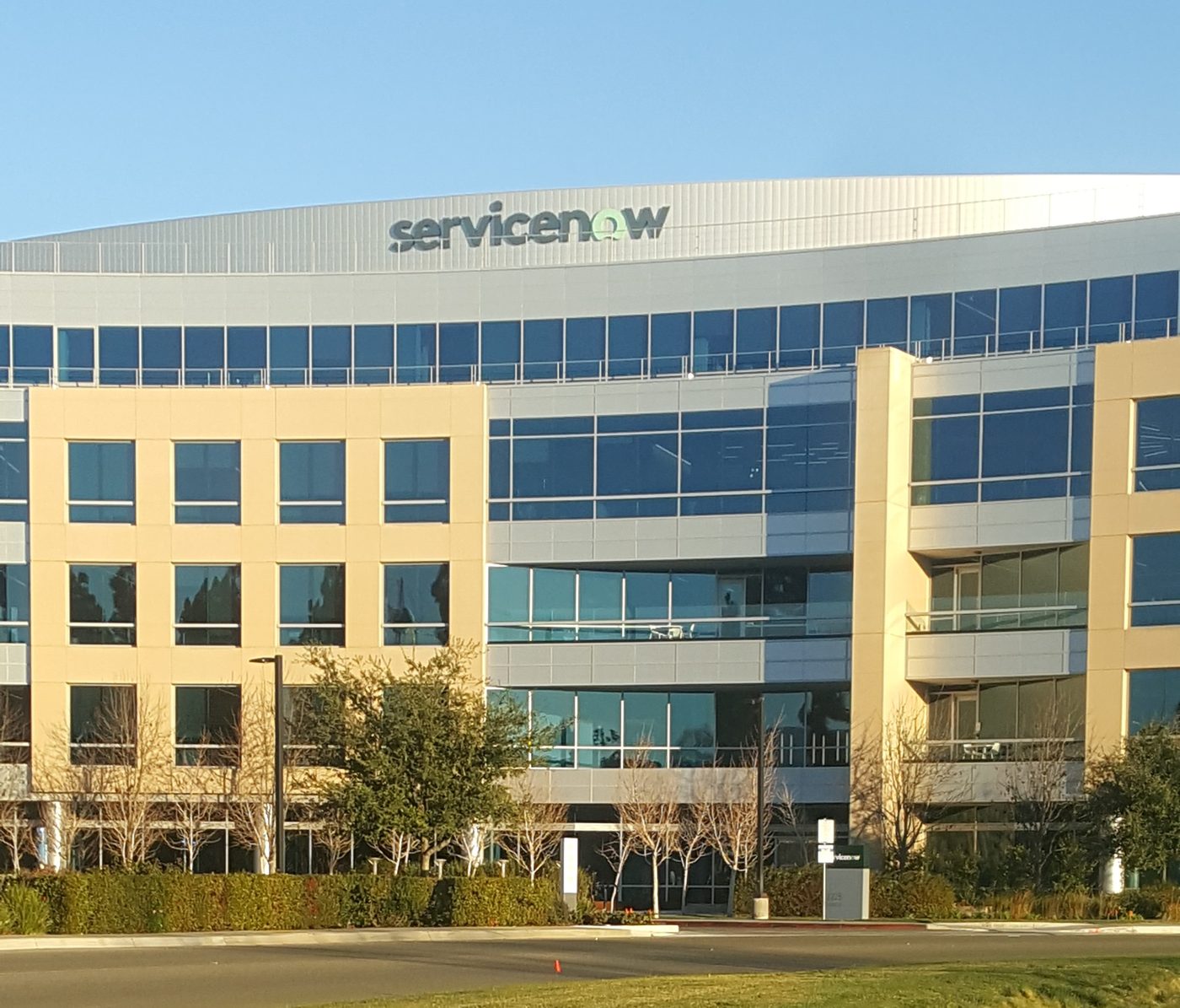 ServiceNow's tan headquarters building with the company logo near the roof