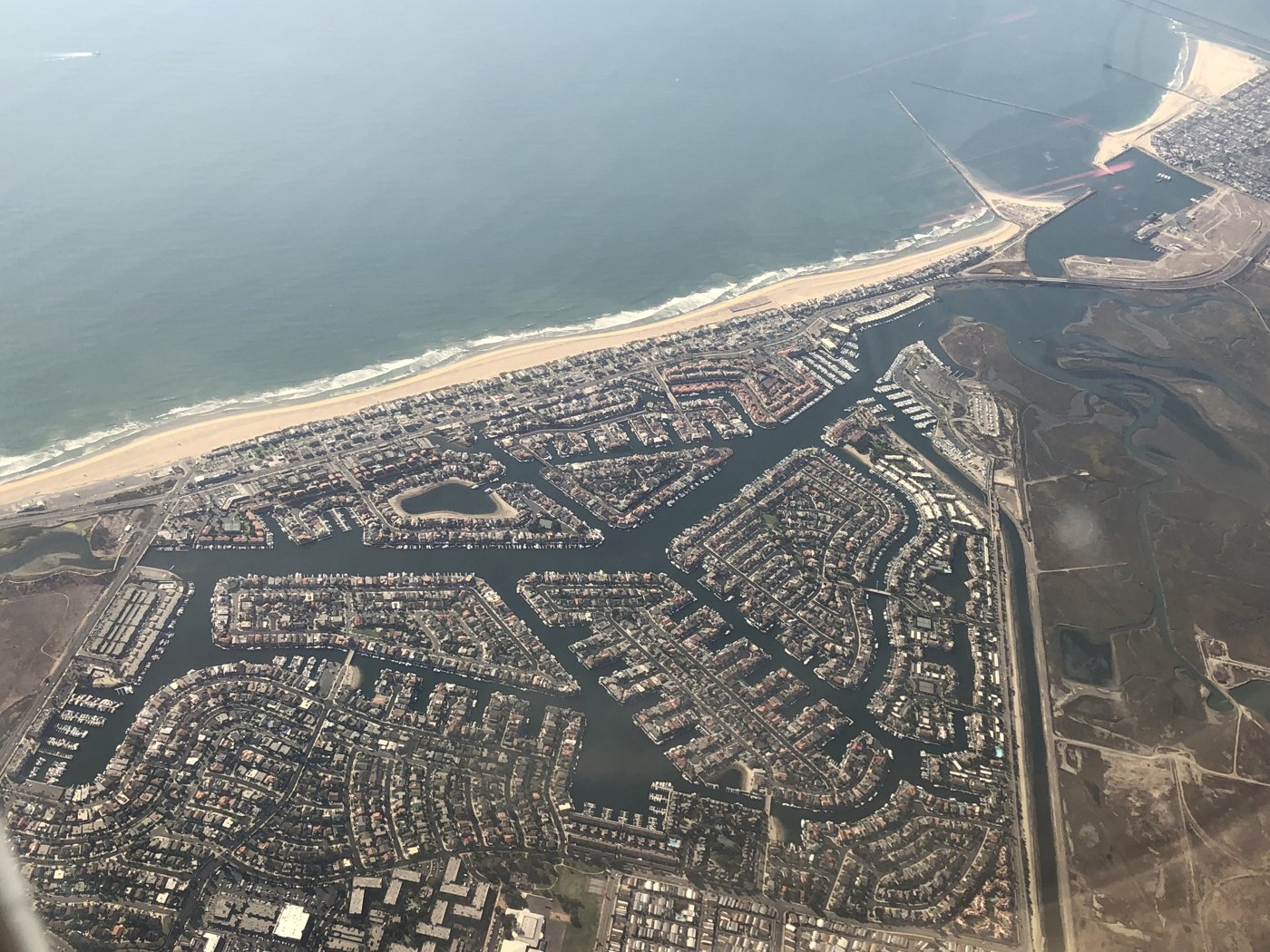 An aerial view of homes along the coast and channels near Huntington Beach, California
