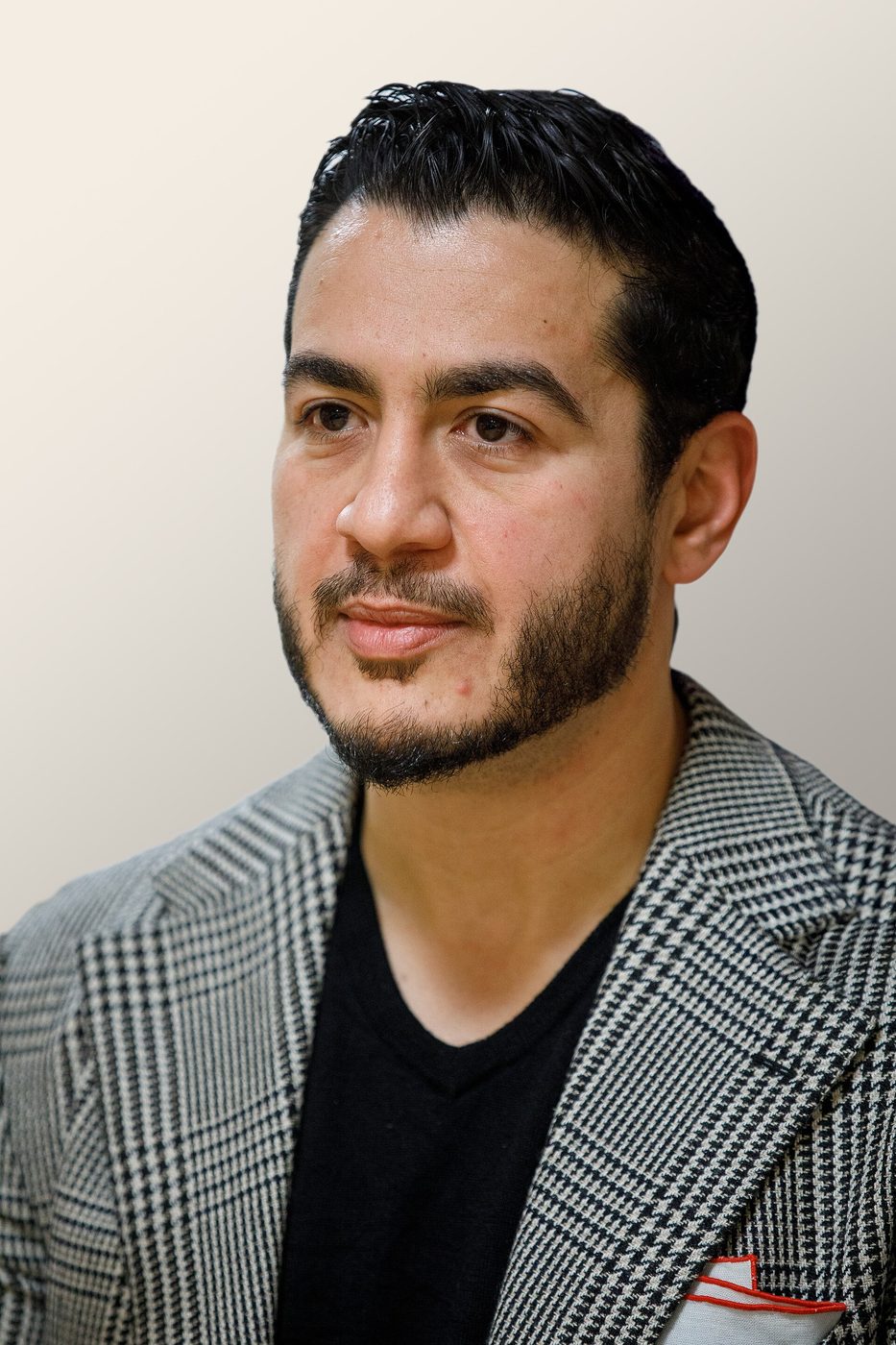 Abdul El-Sayed in a checked jacket over a black shirt