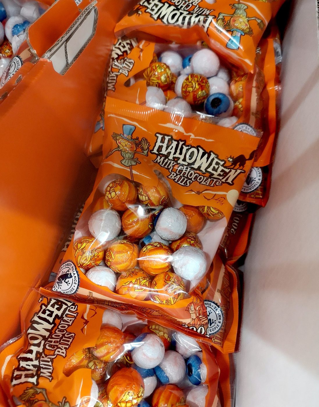 Orange bags of Halloween candy packed in a box