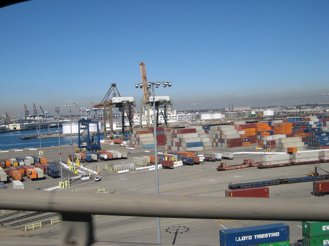 Container cranes and a stacked container yard at the Long Beach port