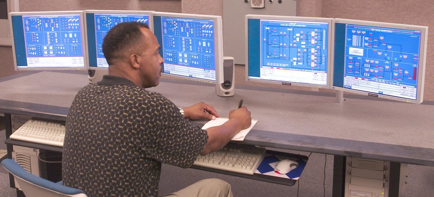 A worker sits at screens in a control room at the Savannah River Site